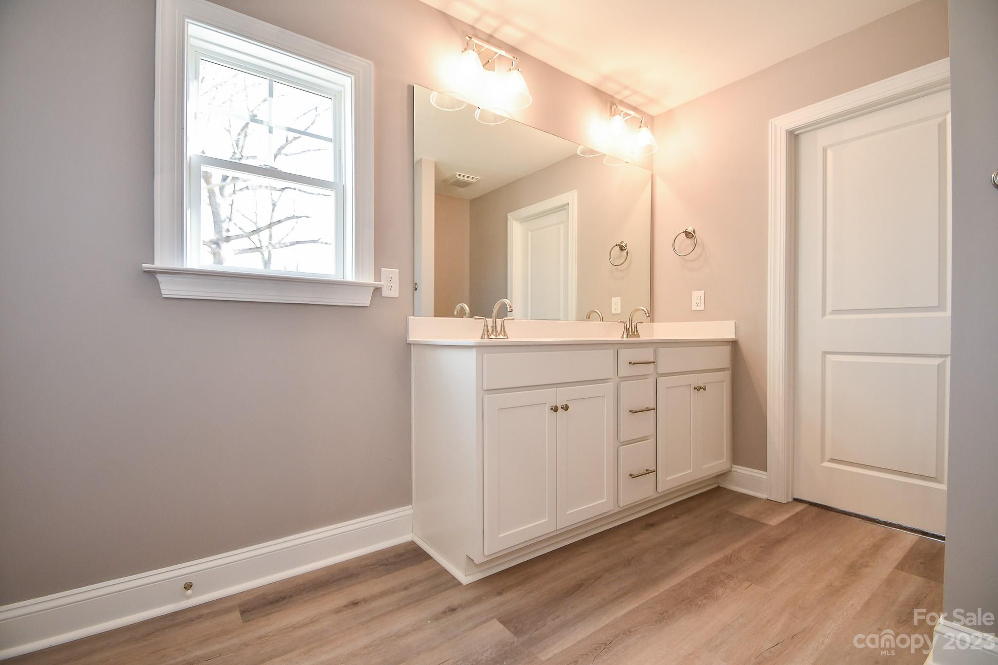 1620 McIntyre Road, Unit 8 Wingate, NC 28174 - Photo 25 of 31 a view of a bathroom with two sinks and a window