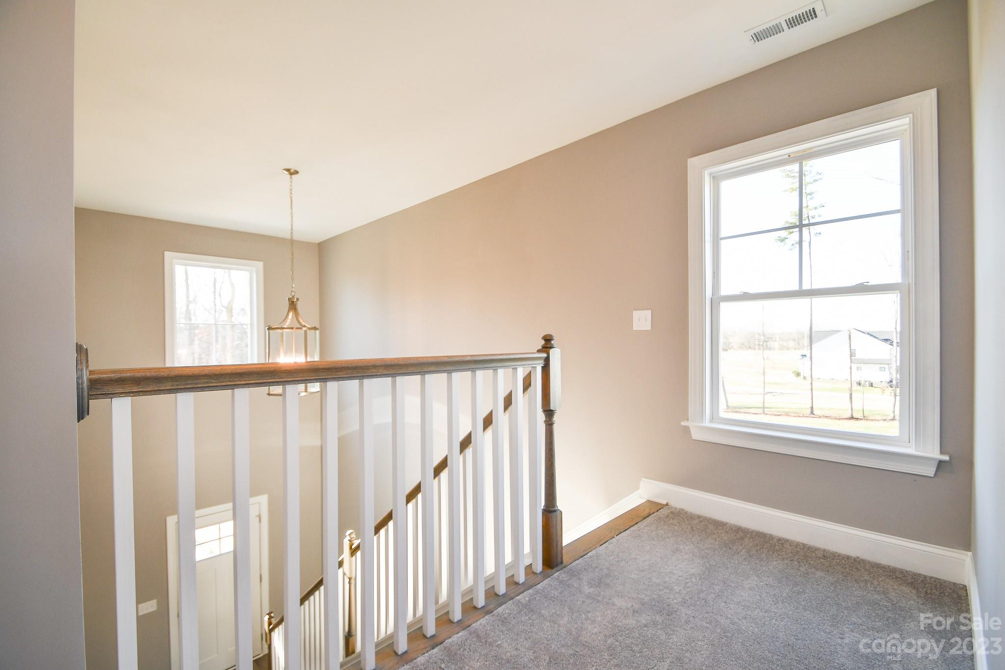 1620 McIntyre Road, Unit 8 Wingate, NC 28174 - Photo 30 of 31 a view of an empty room with wooden floor and a window