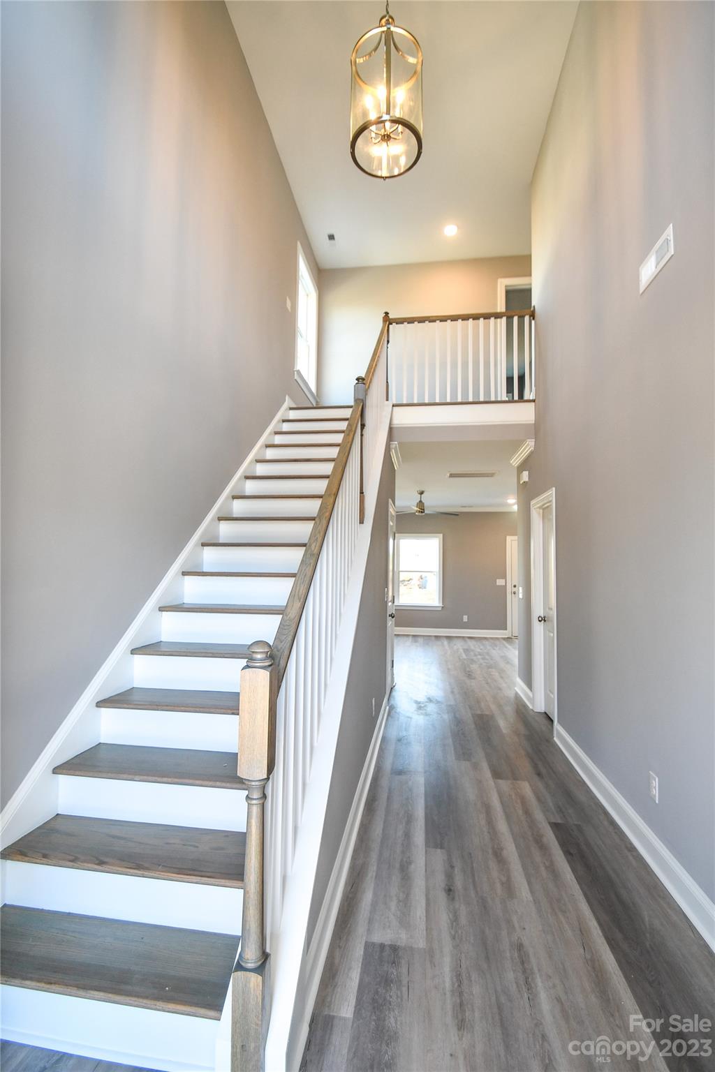 1620 McIntyre Road, Unit 8 Wingate, NC 28174 - Photo 5 of 31 a view of a hallway with wooden floor and staircase