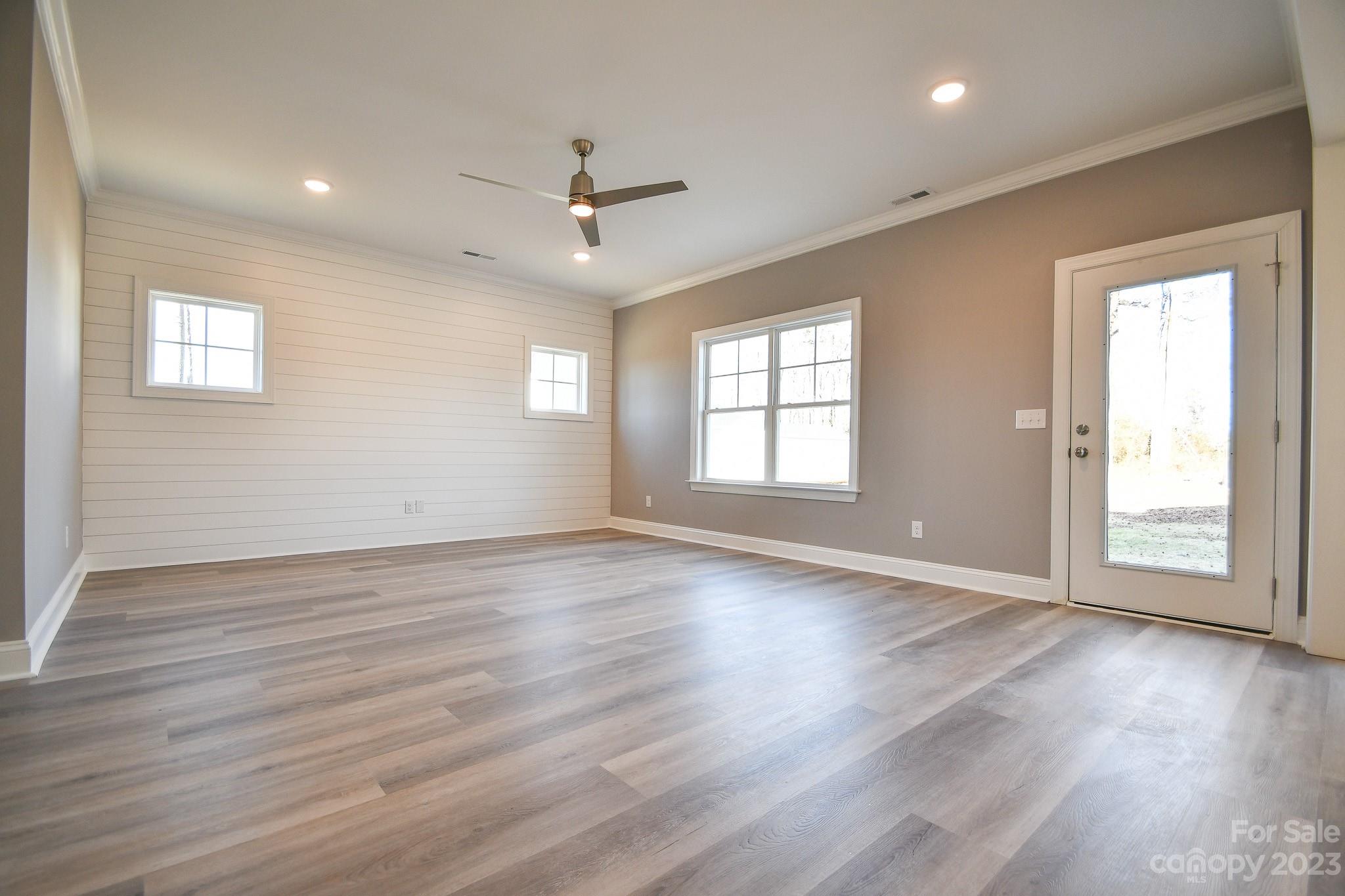 1620 McIntyre Road, Unit 8 Wingate, NC 28174 - Photo 7 of 31 an empty room with wooden floor and windows
