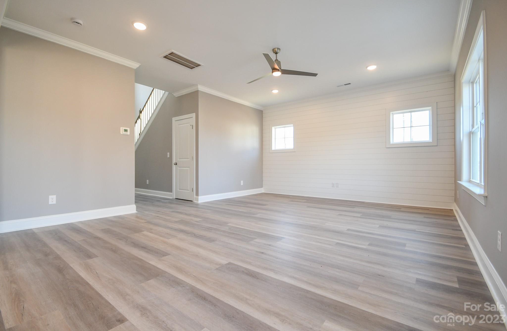 1620 McIntyre Road, Unit 8 Wingate, NC 28174 - Photo 8 of 31 an empty room with wooden floor and windows