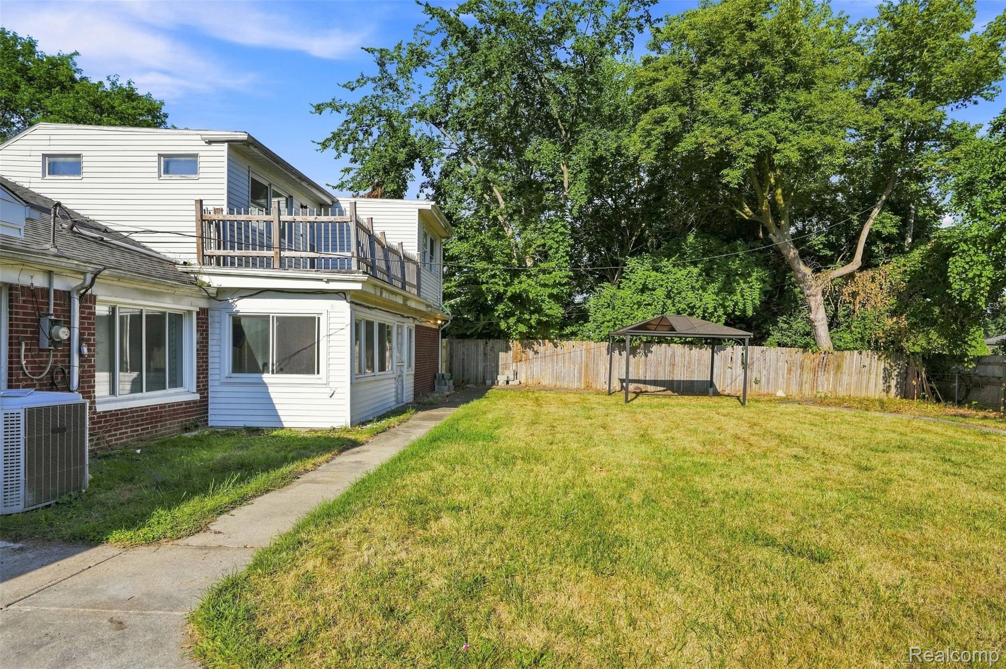 17620 Cornell Road Southfield, MI 48075 - Photo 24 of 29 Expansive backyard with a manicured lawn, established trees, and perimeter fencing