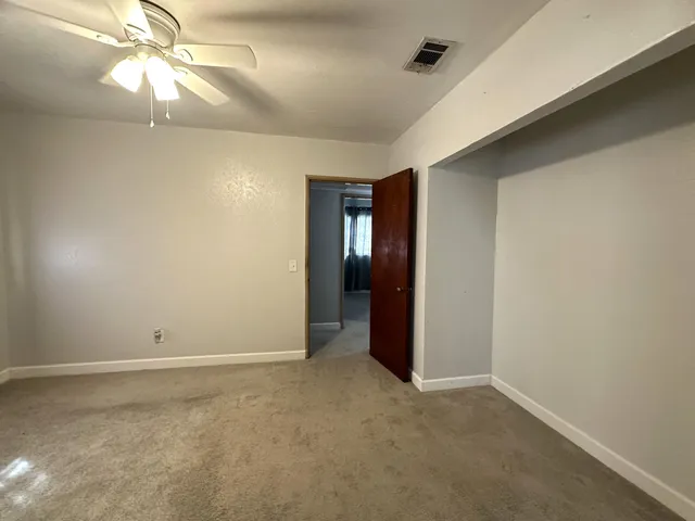 a bathroom with a toilet and a shower curtain