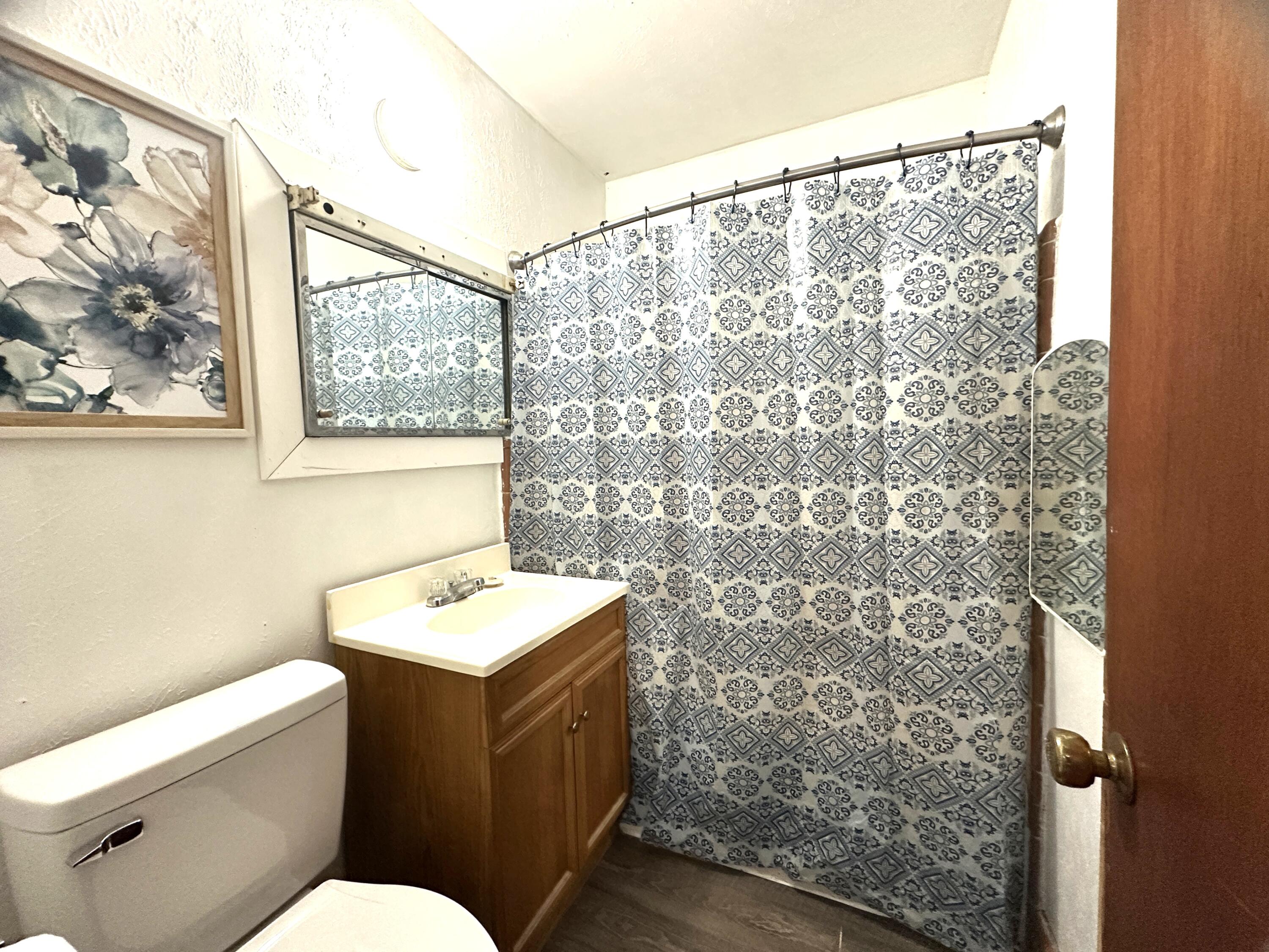 108 Sikes Drive Crestview, FL 32539 - Photo 20 of 41 a bathroom with a toilet and a shower curtain