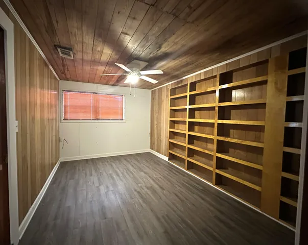 a kitchen with a sink cabinets and wooden floor