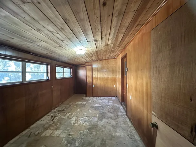 a view of a kitchen with wooden floor and electronic appliances