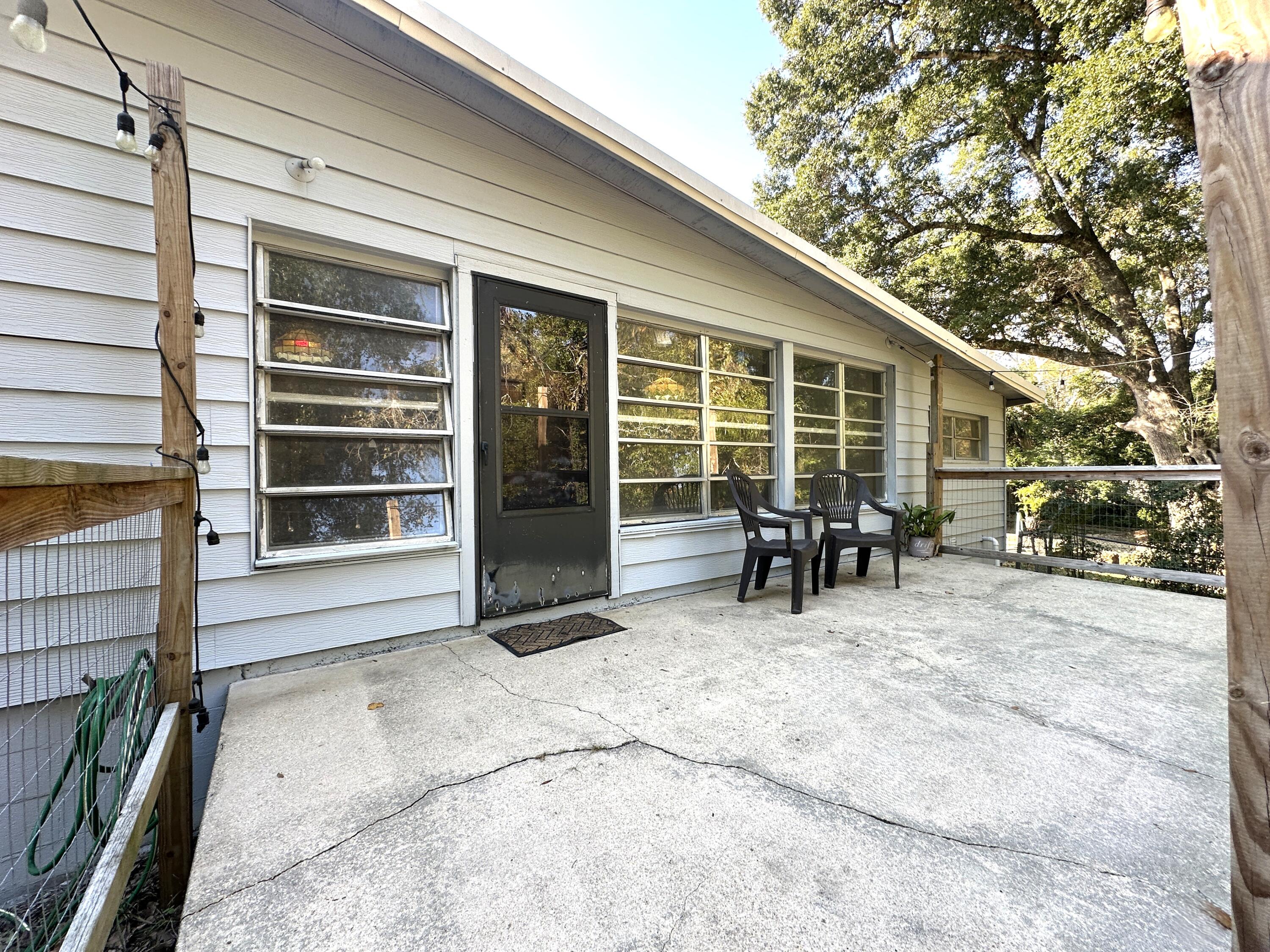 108 Sikes Drive Crestview, FL 32539 - Photo 33 of 41 a view of house with patio outdoor seating and covered with chairs