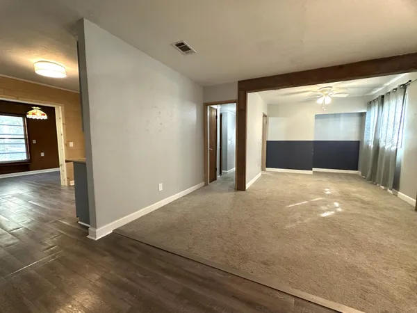 a kitchen with granite countertop a refrigerator oven a sink dishwasher and a stove with wooden floor