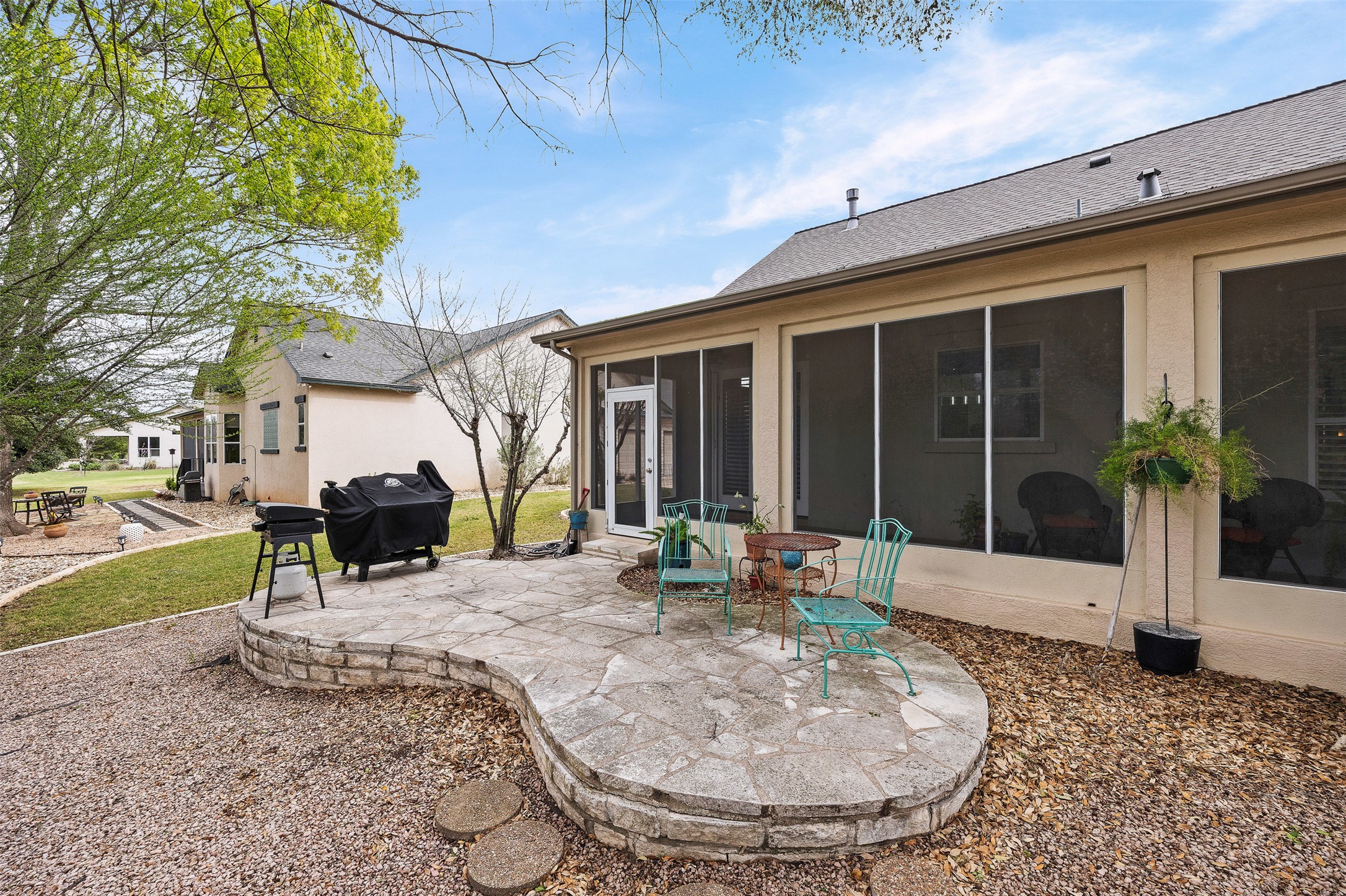144 Stetson Trail Georgetown, TX 78633 - Photo 33 of 39 Back of property featuring a stone patio and grill area for gatherings or relaxation time