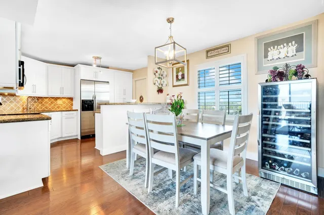 a kitchen with granite countertop stainless steel appliances and white cabinets