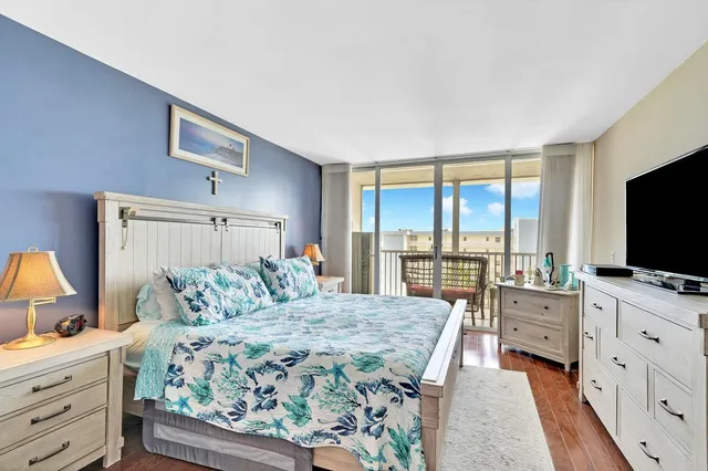 a bedroom with a large bed and a flat screen tv