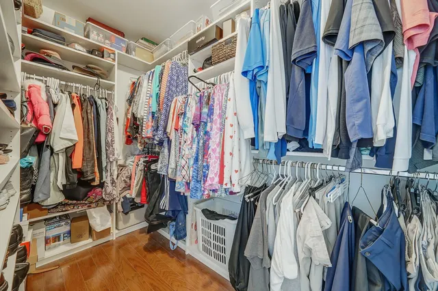 a view of walk in closet with clothes