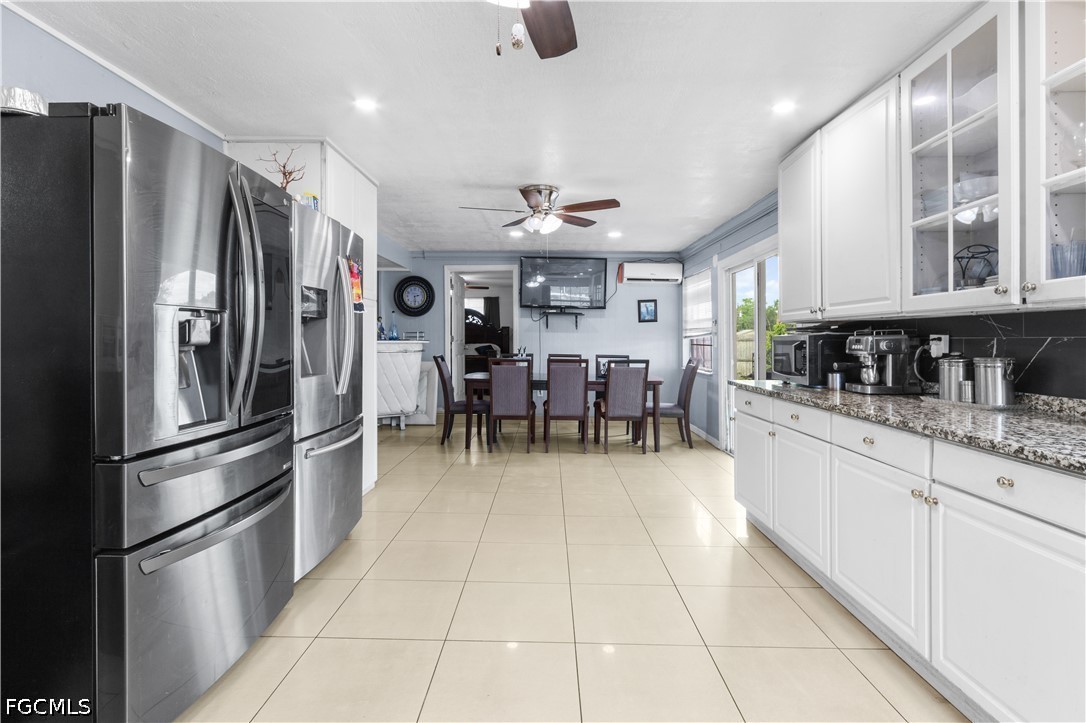 18 Illinois Road Lehigh Acres, FL 33936 - Photo 19 of 45 a kitchen with stainless steel appliances granite countertop a refrigerator and microwave