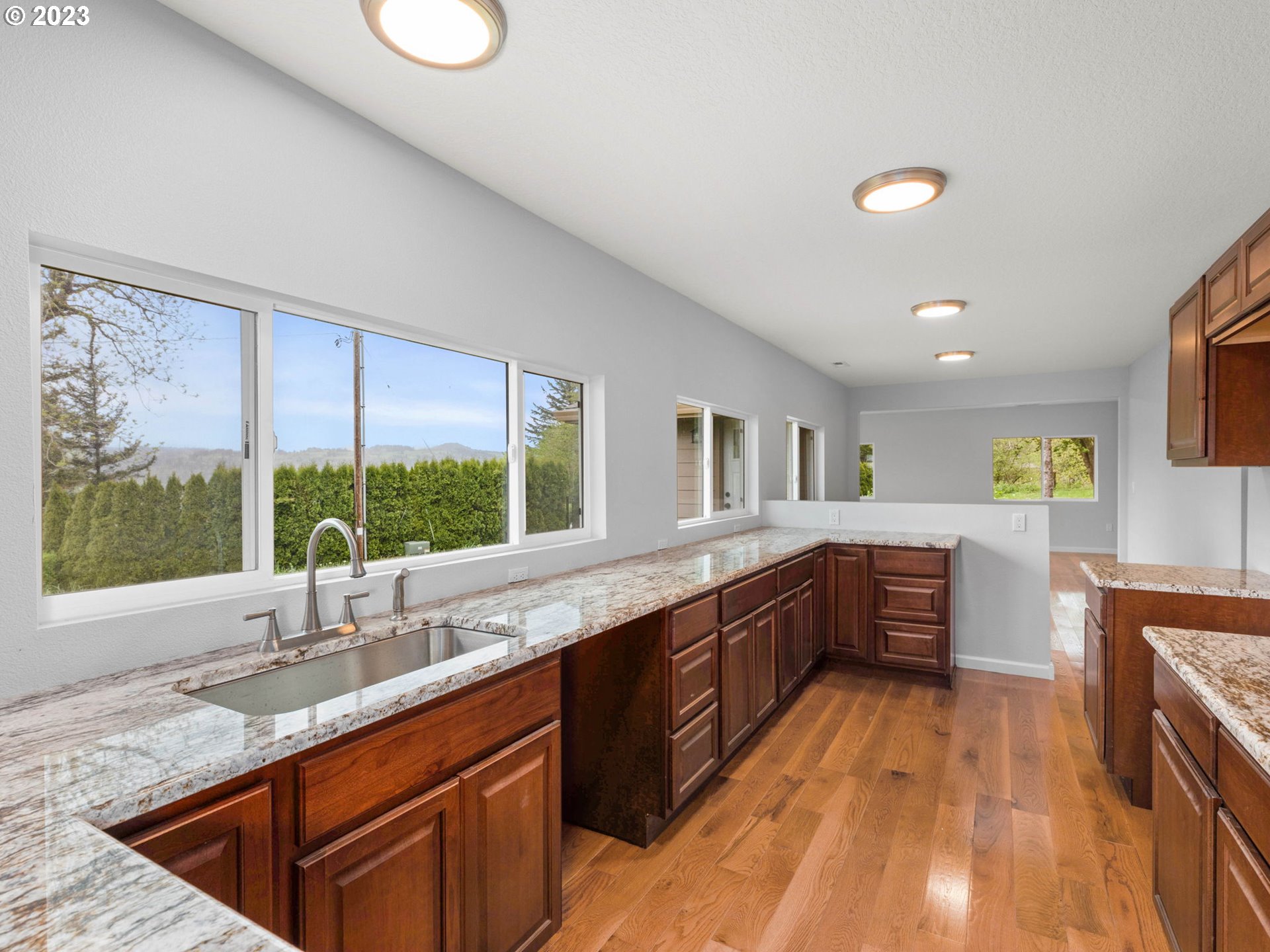 36810 Northeast Reed Road Corbett, OR 97019 - Photo 11 of 28 a large kitchen with kitchen island granite countertop a large window