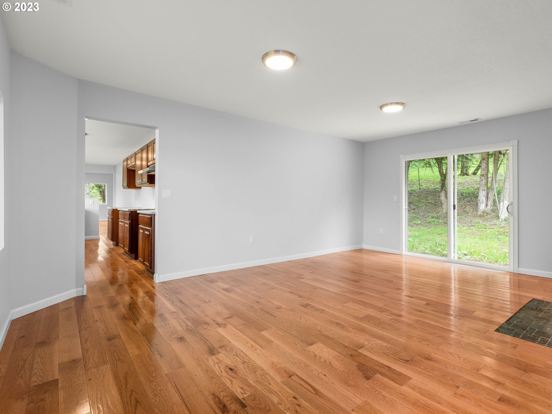 36810 Northeast Reed Road Corbett, OR 97019 - Photo 15 of 28 a view of an empty room with wooden floor and a window