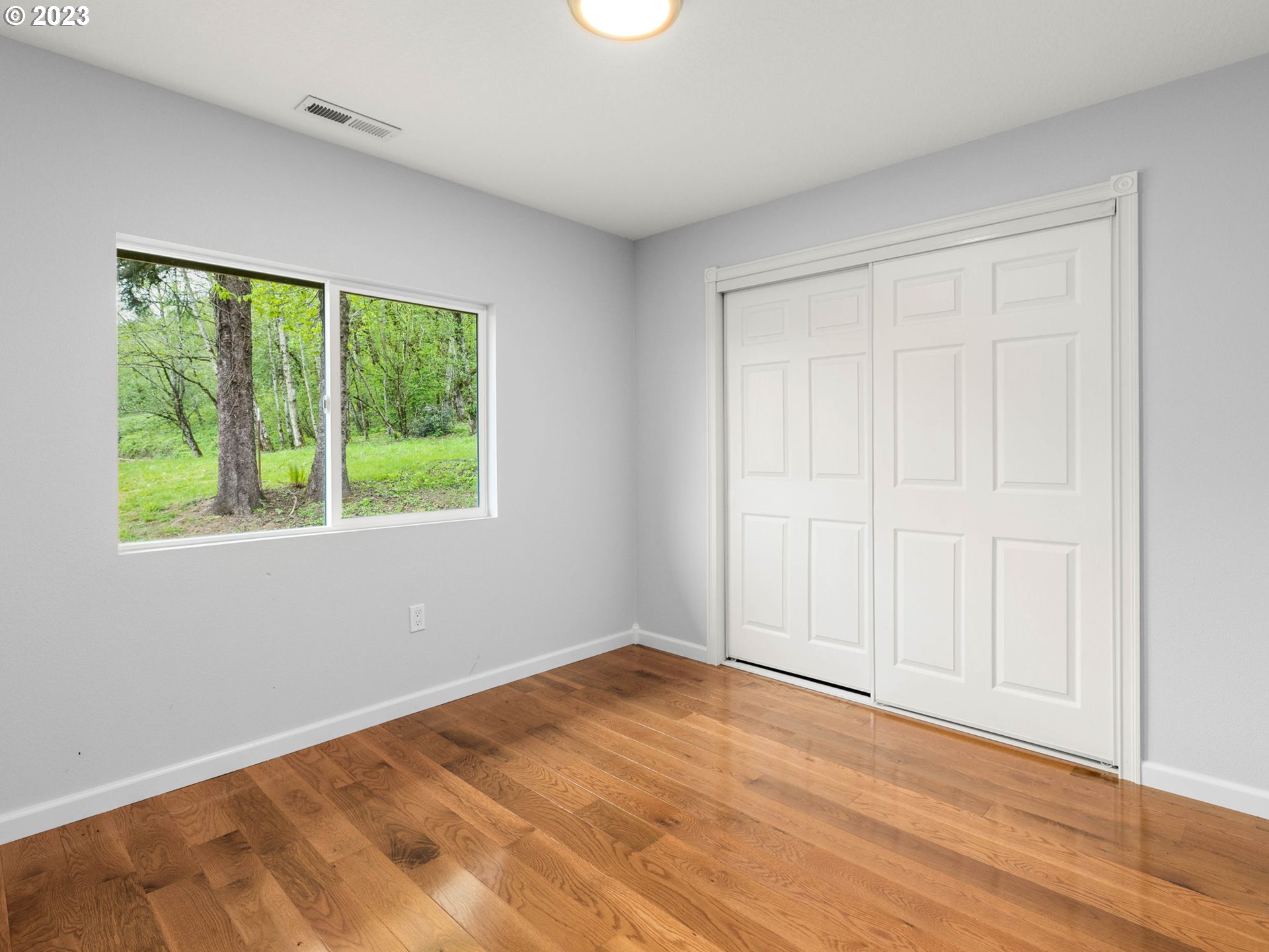 36810 Northeast Reed Road Corbett, OR 97019 - Photo 16 of 28 a view of an empty room with wooden floor and a window