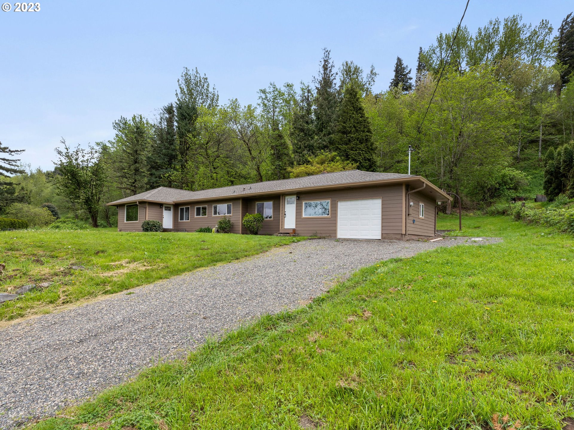 36810 Northeast Reed Road Corbett, OR 97019 - Photo 3 of 28 a front view of a house with yard and green space