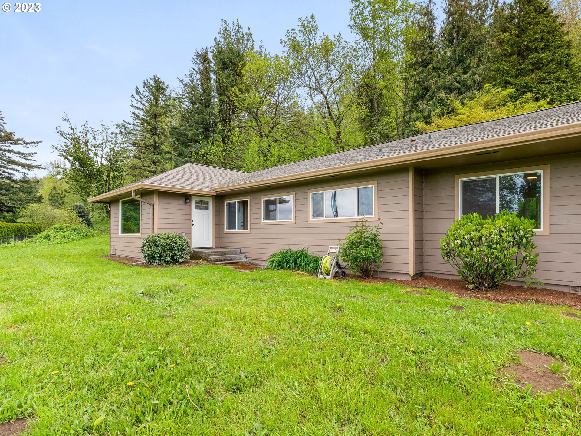 36810 Northeast Reed Road Corbett, OR 97019 - Photo 4 of 28 a front view of a house with a yard