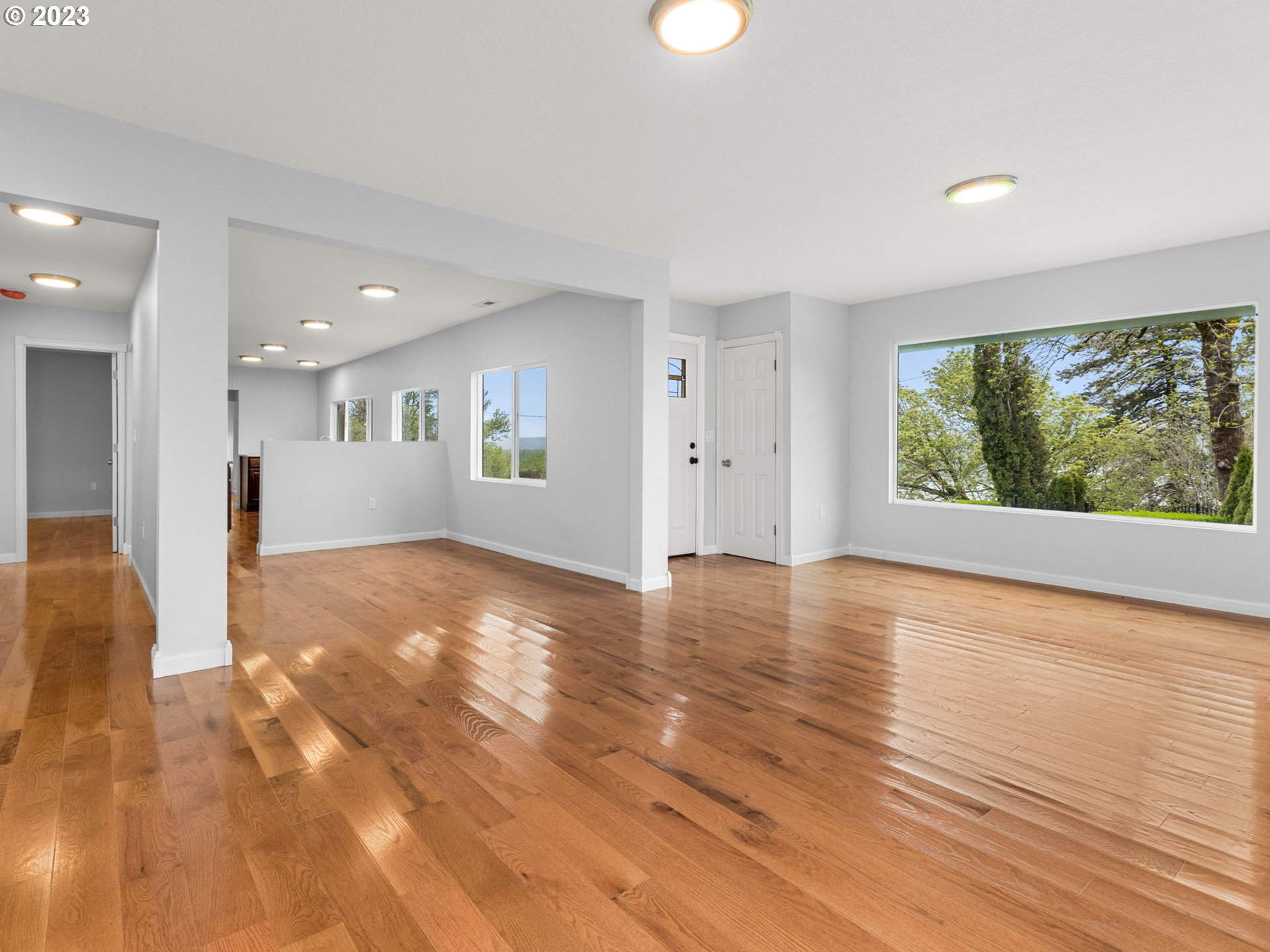 36810 Northeast Reed Road Corbett, OR 97019 - Photo 8 of 28 a view of an empty room with wooden floor and a window