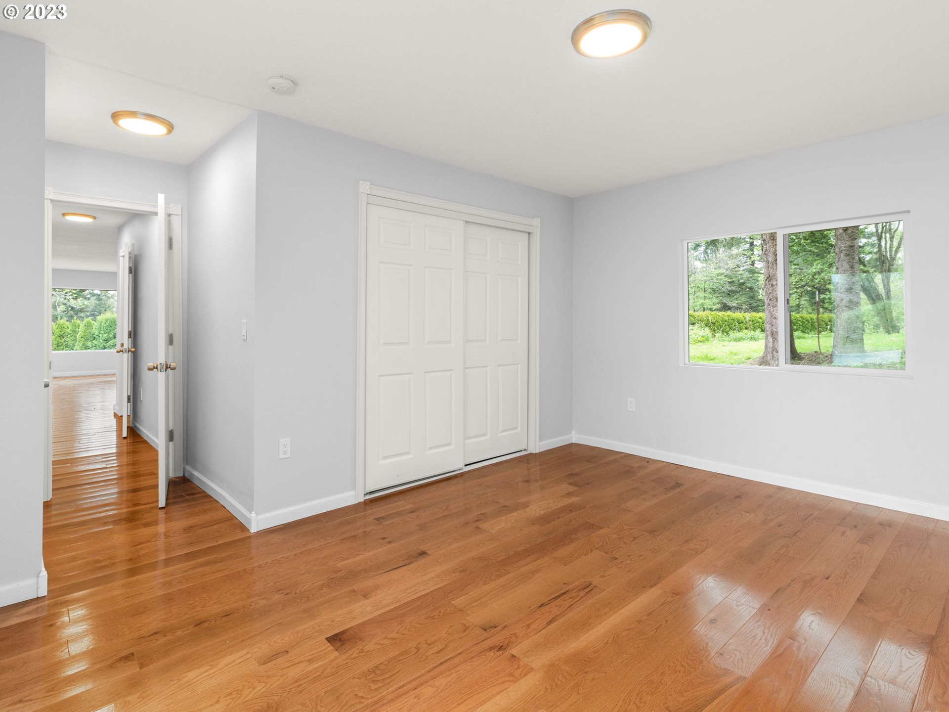 36810 Northeast Reed Road Corbett, OR 97019 - Photo 10 of 28 a view of an empty room with wooden floor and a window