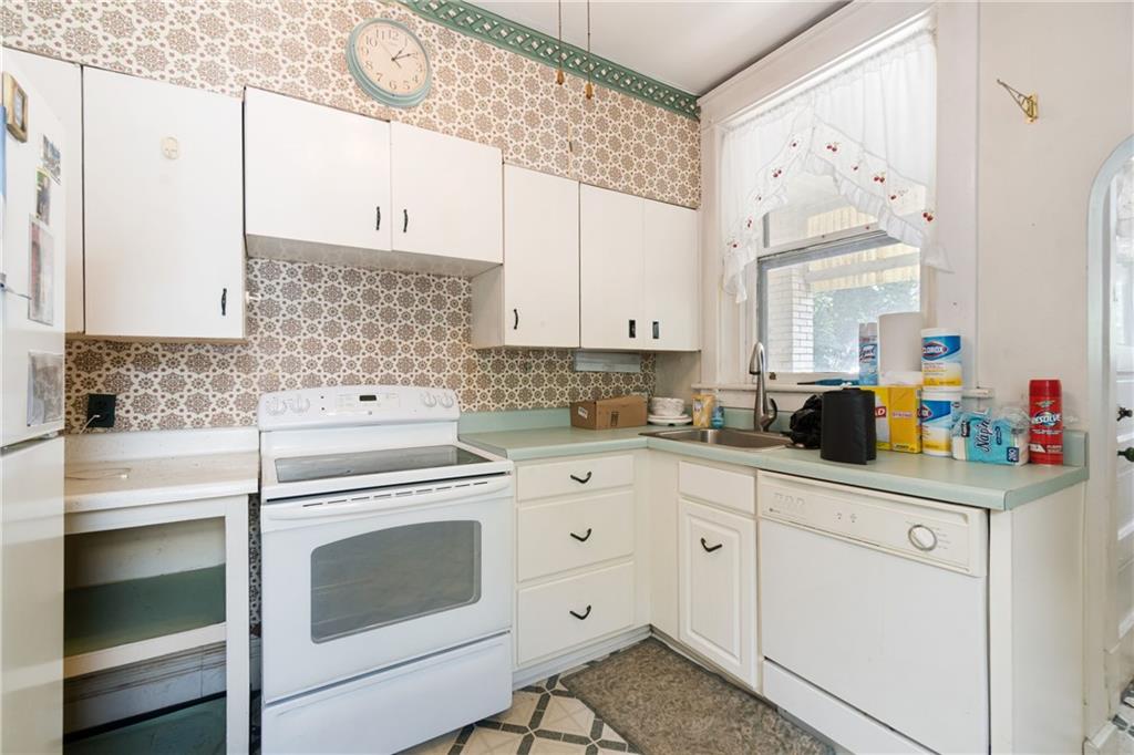 1300 Beechview Avenue Beechview, PA 15216 - Photo 12 of 31 a kitchen with white cabinets and white appliances