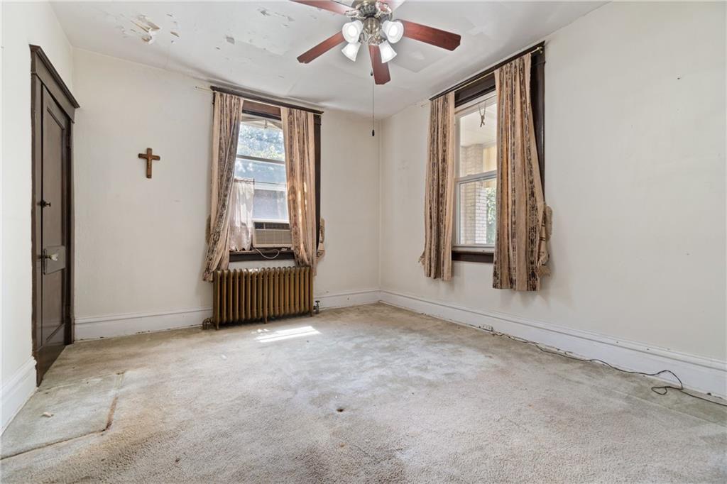 1300 Beechview Avenue Beechview, PA 15216 - Photo 14 of 31 an empty room with windows and ceiling fan