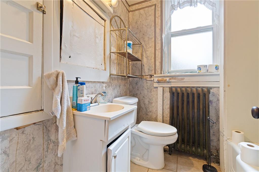 1300 Beechview Avenue Beechview, PA 15216 - Photo 15 of 31 a bathroom with a sink a toilet and a mirror