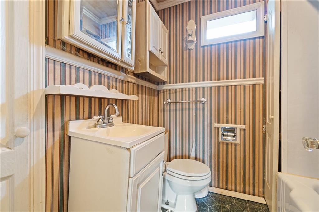1300 Beechview Avenue Beechview, PA 15216 - Photo 27 of 31 a bathroom with a sink a toilet and a window