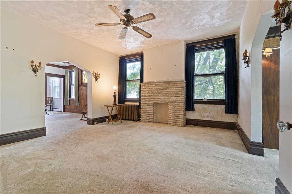 1300 Beechview Avenue Beechview, PA 15216 - Photo 5 of 31 an empty room with windows and fan chandelier