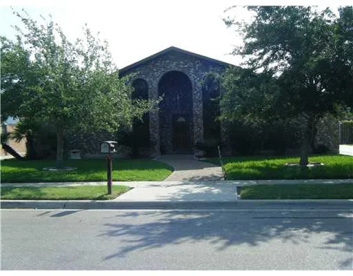 a view of a yard in front of a brick house