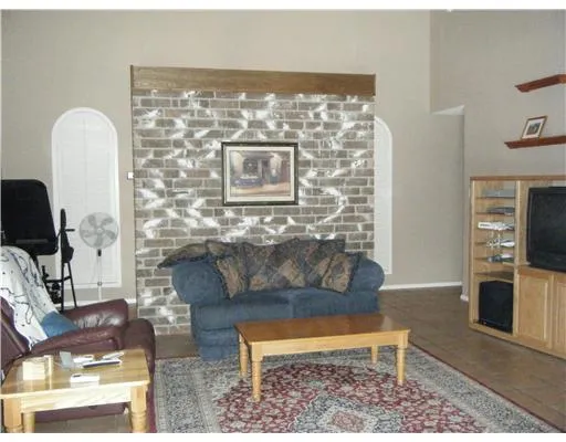 a living room with furniture a rug and a fireplace