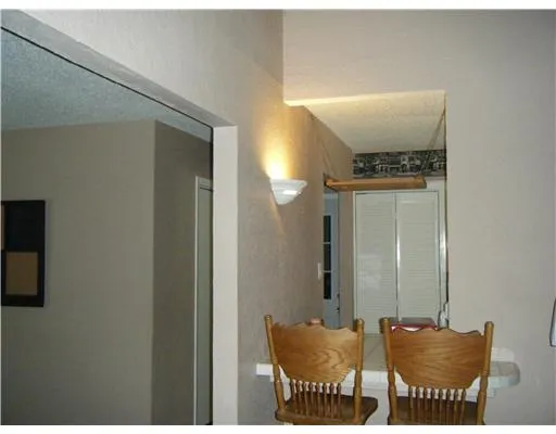 a view of a room that has a table and chairs in it