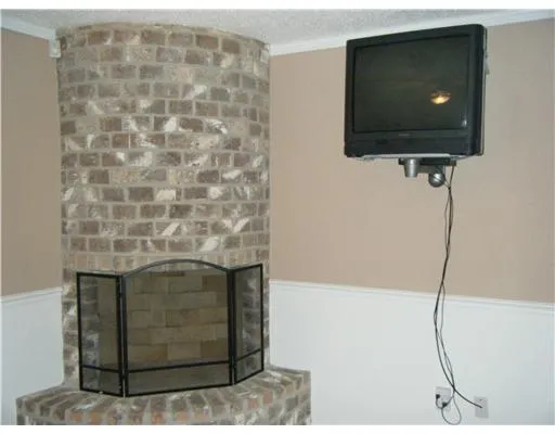 a living room with a flat screen tv and a floor to ceiling window