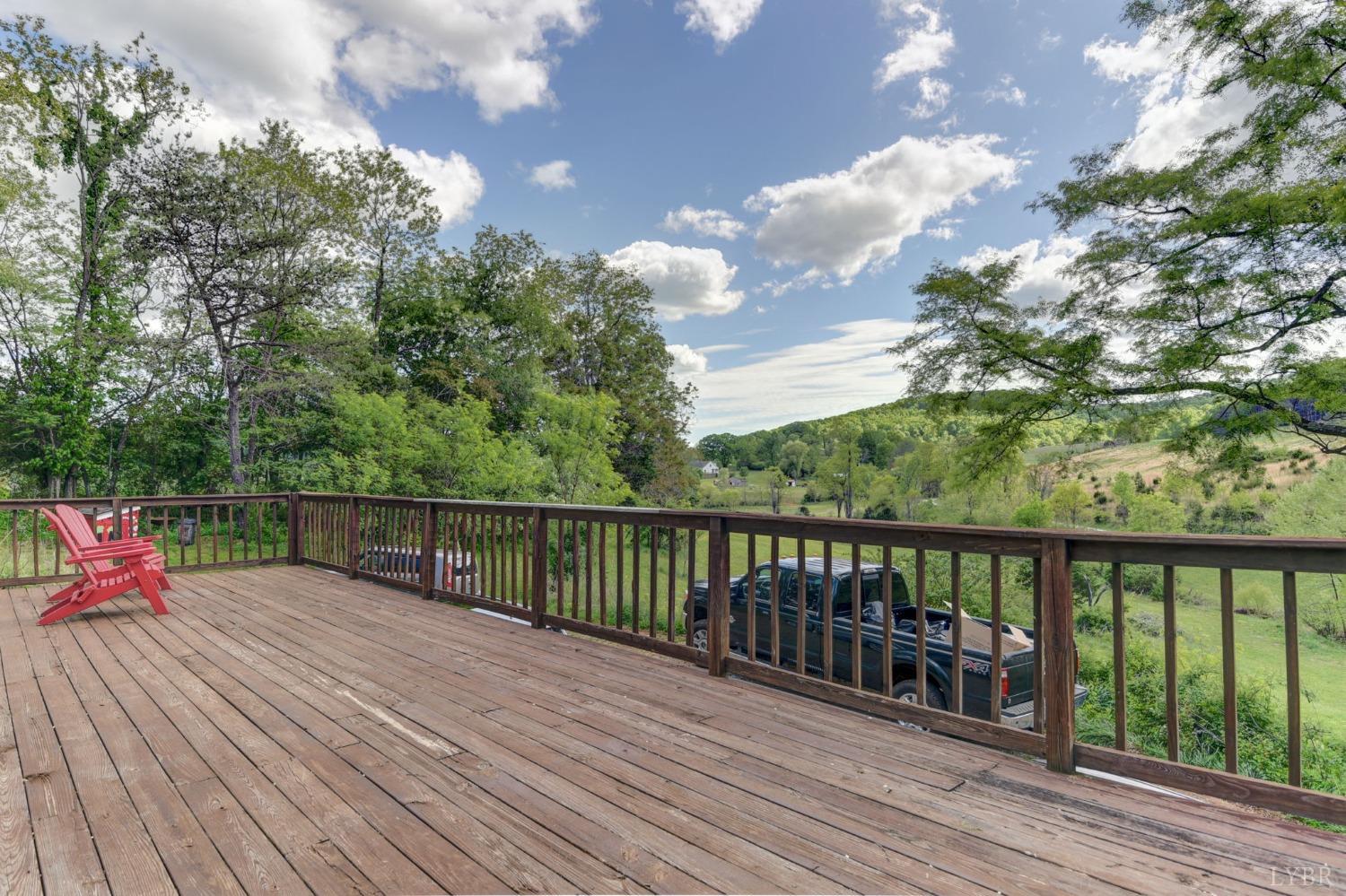 1112 Twinleaf Road Goode, VA 24556 - Photo 21 of 36 a balcony with wooden floor and city view