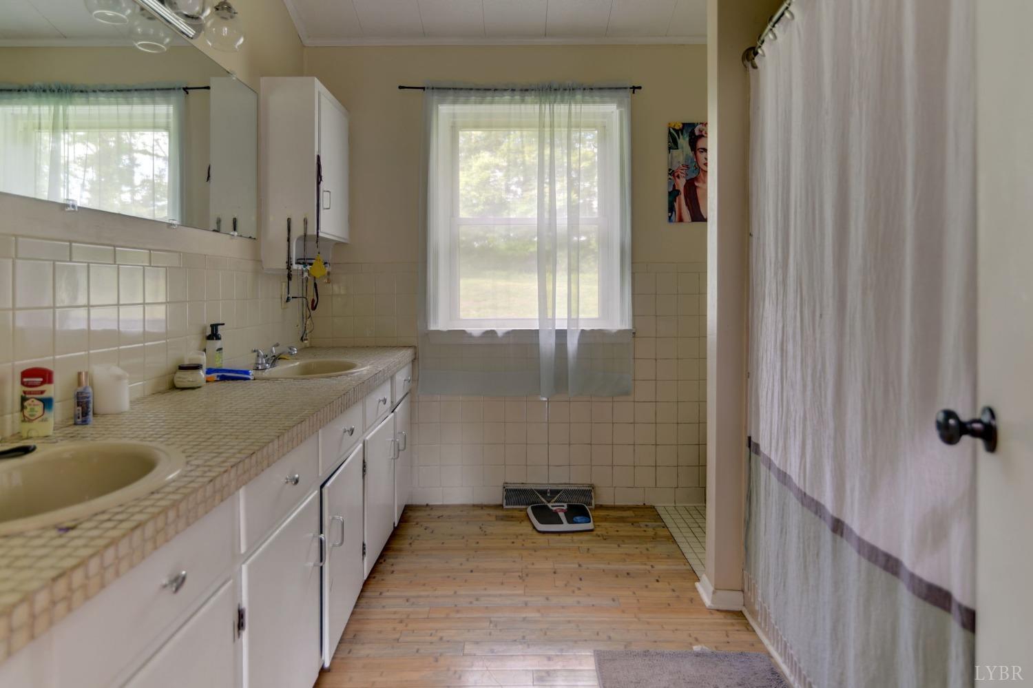 1112 Twinleaf Road Goode, VA 24556 - Photo 9 of 36 a bathroom with a sink and a mirror