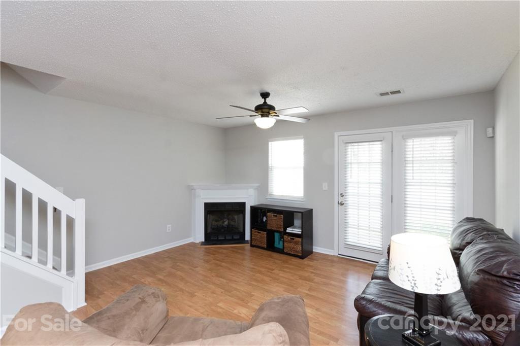 8246 Rudolph Road Charlotte, NC 28216 - Photo 11 of 29 a living room with furniture window and a fireplace