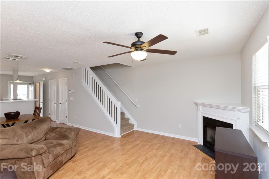 8246 Rudolph Road Charlotte, NC 28216 - Photo 12 of 29 a bed room with a bed and a ceiling fan