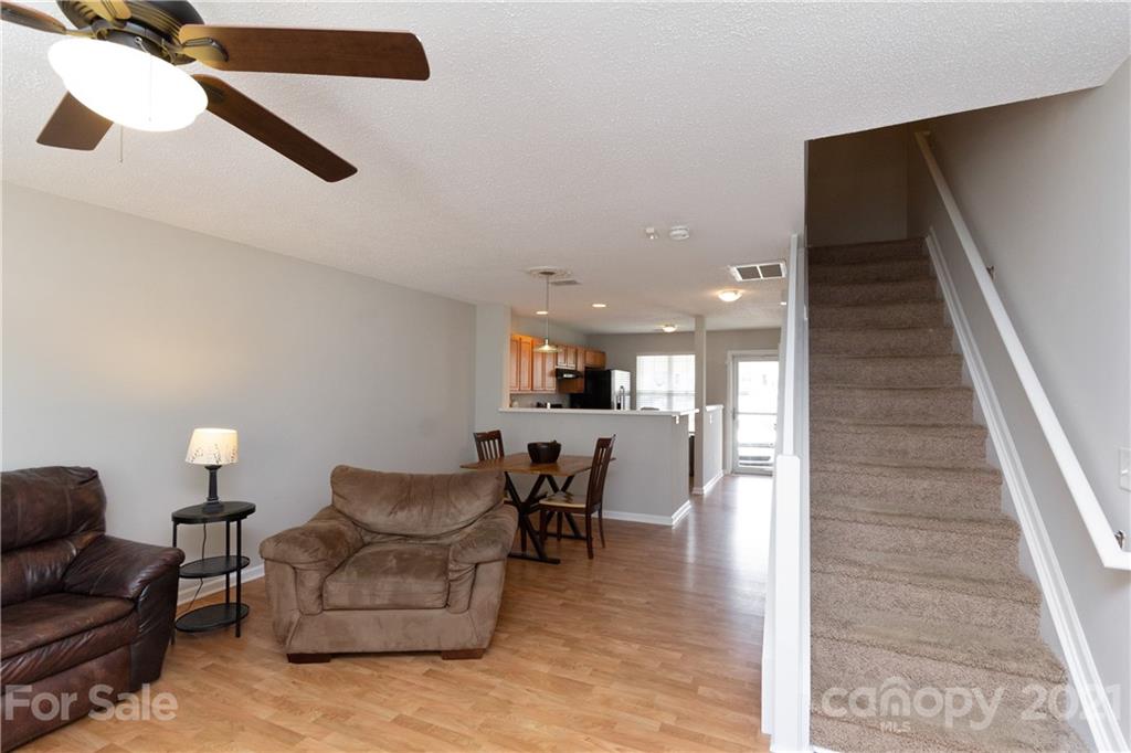 8246 Rudolph Road Charlotte, NC 28216 - Photo 13 of 29 a living room with furniture and a chandelier