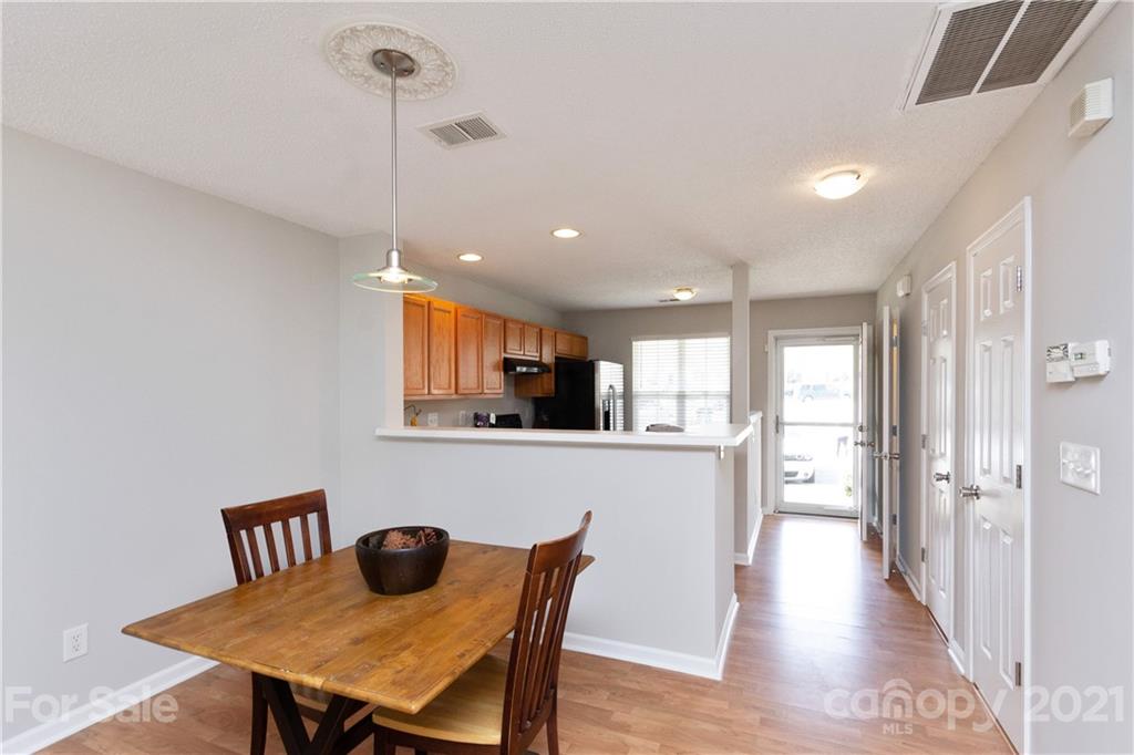 8246 Rudolph Road Charlotte, NC 28216 - Photo 15 of 29 a view of a dining room with furniture