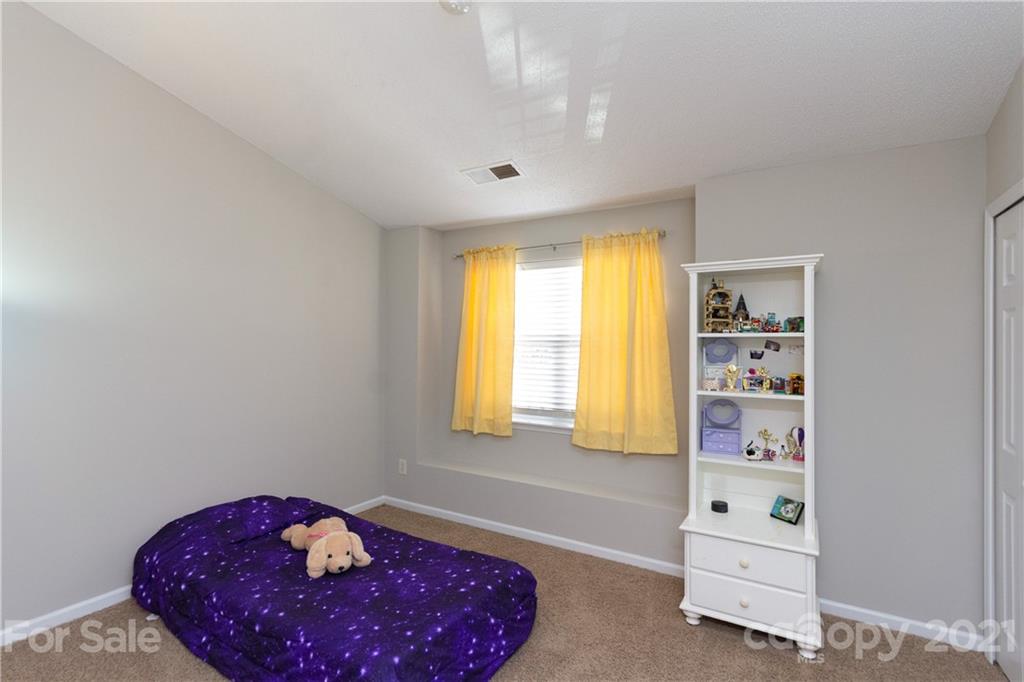 8246 Rudolph Road Charlotte, NC 28216 - Photo 16 of 29 a bedroom with a bed and a window