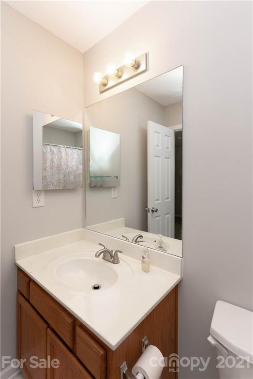 8246 Rudolph Road Charlotte, NC 28216 - Photo 19 of 29 a bathroom with a sink and a mirror