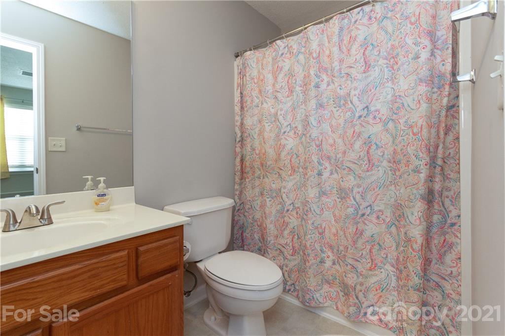8246 Rudolph Road Charlotte, NC 28216 - Photo 20 of 29 a bathroom with a toilet sink and mirror