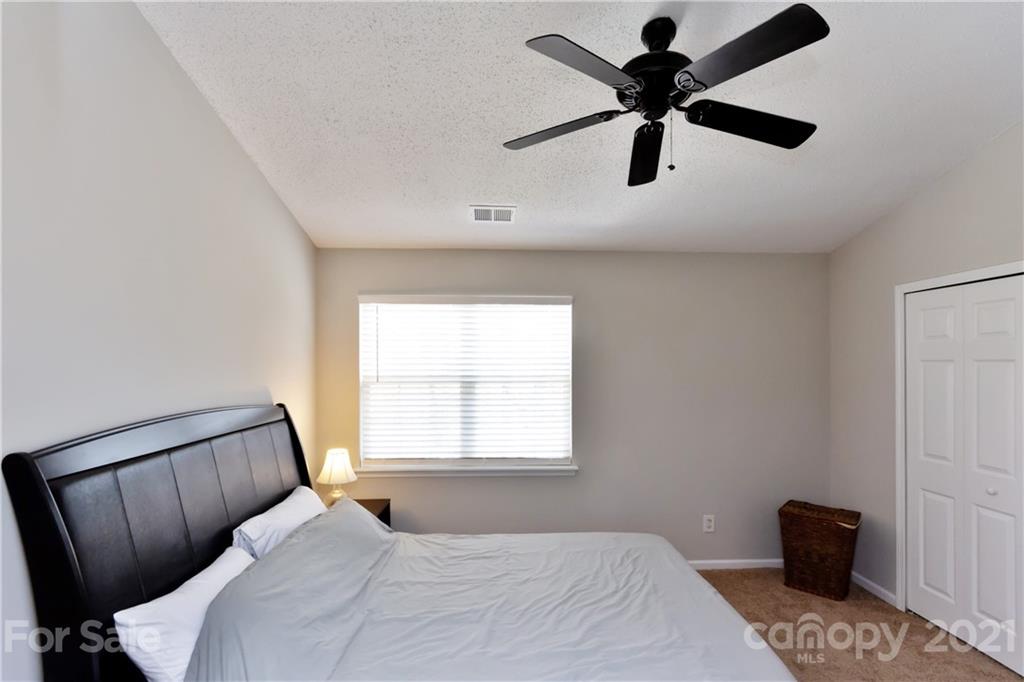 8246 Rudolph Road Charlotte, NC 28216 - Photo 22 of 29 a bedroom with a bed and a window