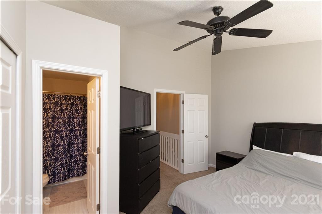 8246 Rudolph Road Charlotte, NC 28216 - Photo 24 of 29 a bedroom with a bed and a walk in closet