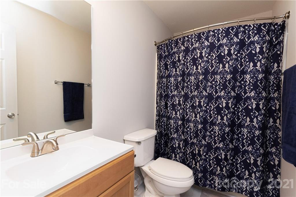 8246 Rudolph Road Charlotte, NC 28216 - Photo 25 of 29 a bathroom with a sink toilet and mirror