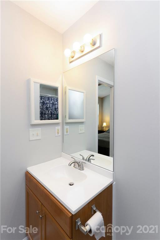 8246 Rudolph Road Charlotte, NC 28216 - Photo 26 of 29 a bathroom with a sink and a mirror