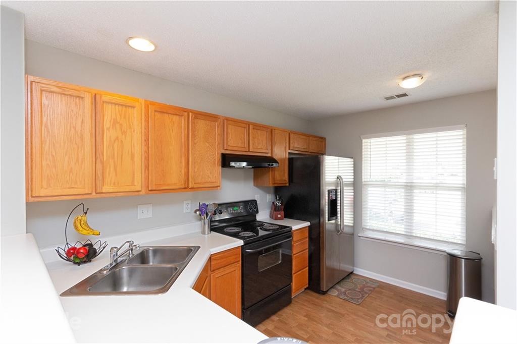8246 Rudolph Road Charlotte, NC 28216 - Photo 4 of 29 a kitchen that has a sink and a stove in it