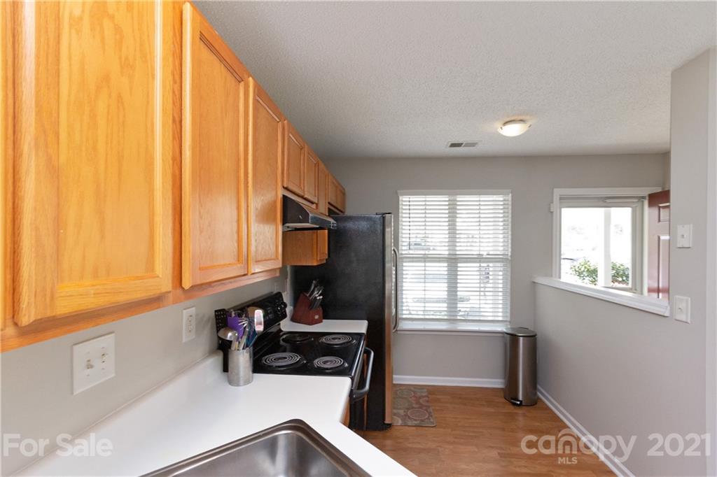 8246 Rudolph Road Charlotte, NC 28216 - Photo 5 of 29 a kitchen with a sink a window and cabinets