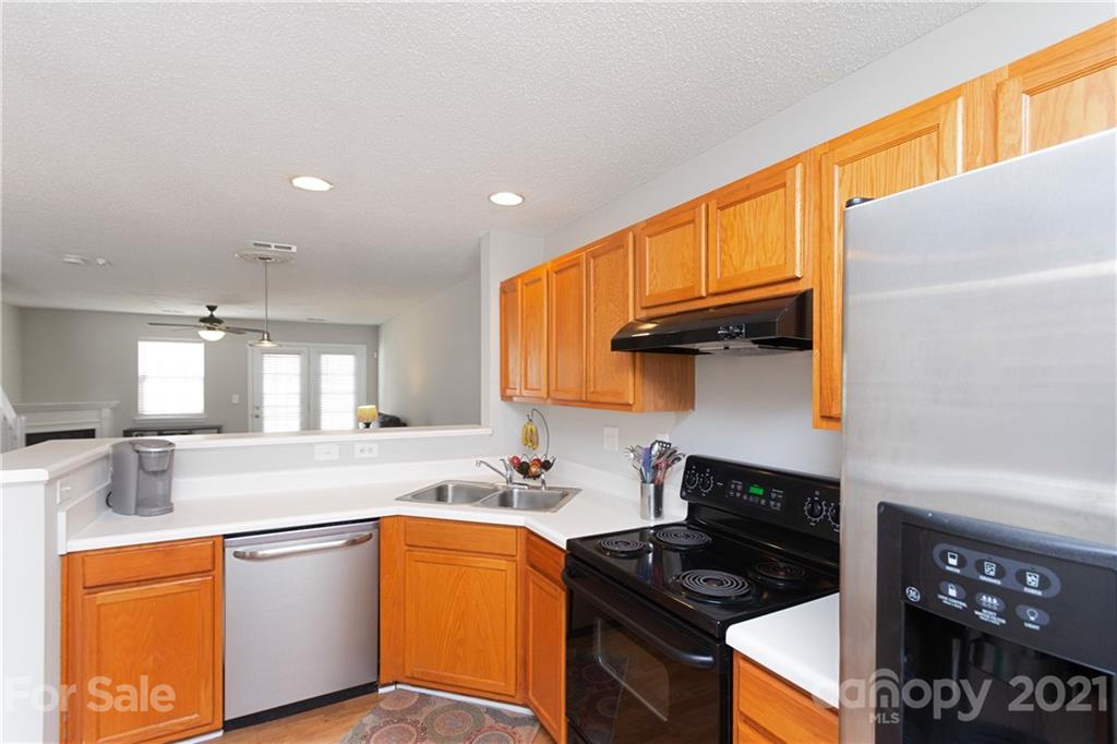 8246 Rudolph Road Charlotte, NC 28216 - Photo 6 of 29 a kitchen with stainless steel appliances a sink stove and cabinets