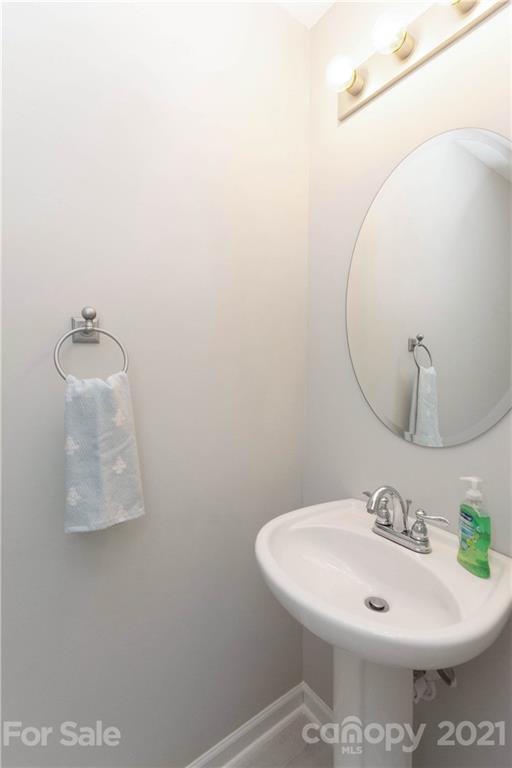 8246 Rudolph Road Charlotte, NC 28216 - Photo 7 of 29 a bathroom with a sink and mirror